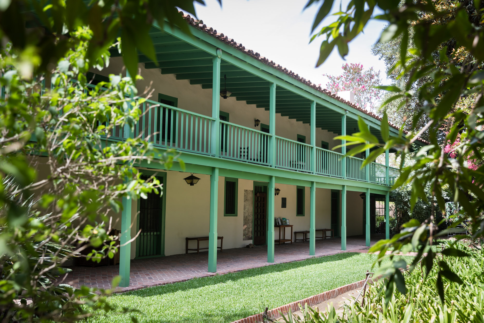 The green, two-story exterior of the main house at Rancho Los Cerritos for an article on where to propose in Long Beach