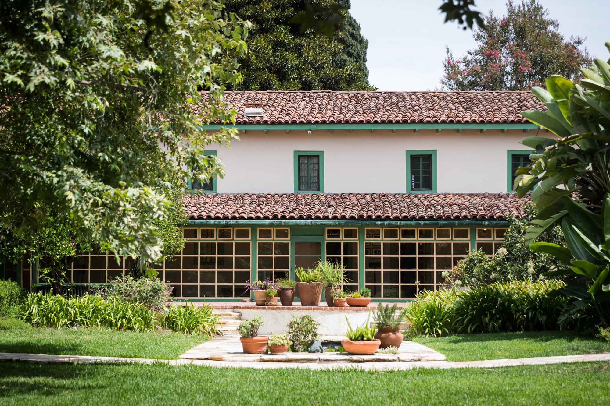 The front of the main house with potted plants and grass at Rancho Los Cerritos for an article on where to propose in Long Beach
