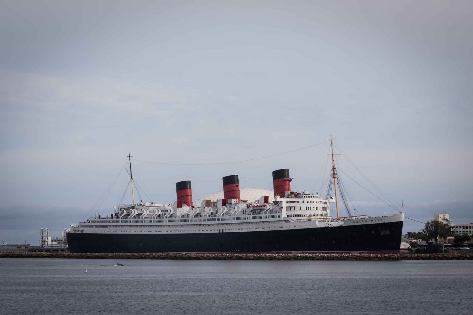A wide view of the Queen Mary in its entirety in the water for an article on where to propose in Long Beach