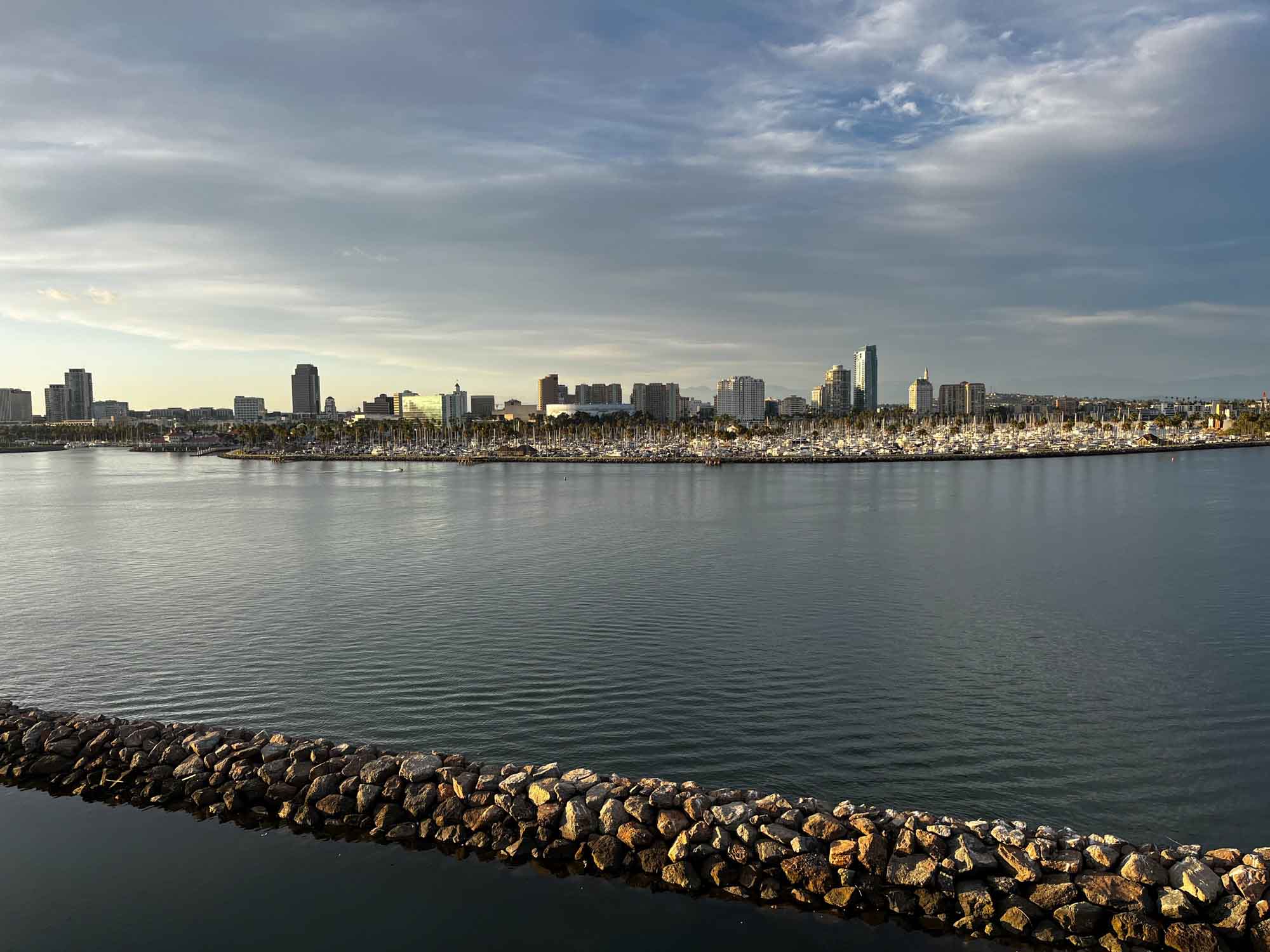 View of Long Beach skyline and rock jetty in the water as seen from the Queen Mary for an article on where to propose in Long Beach