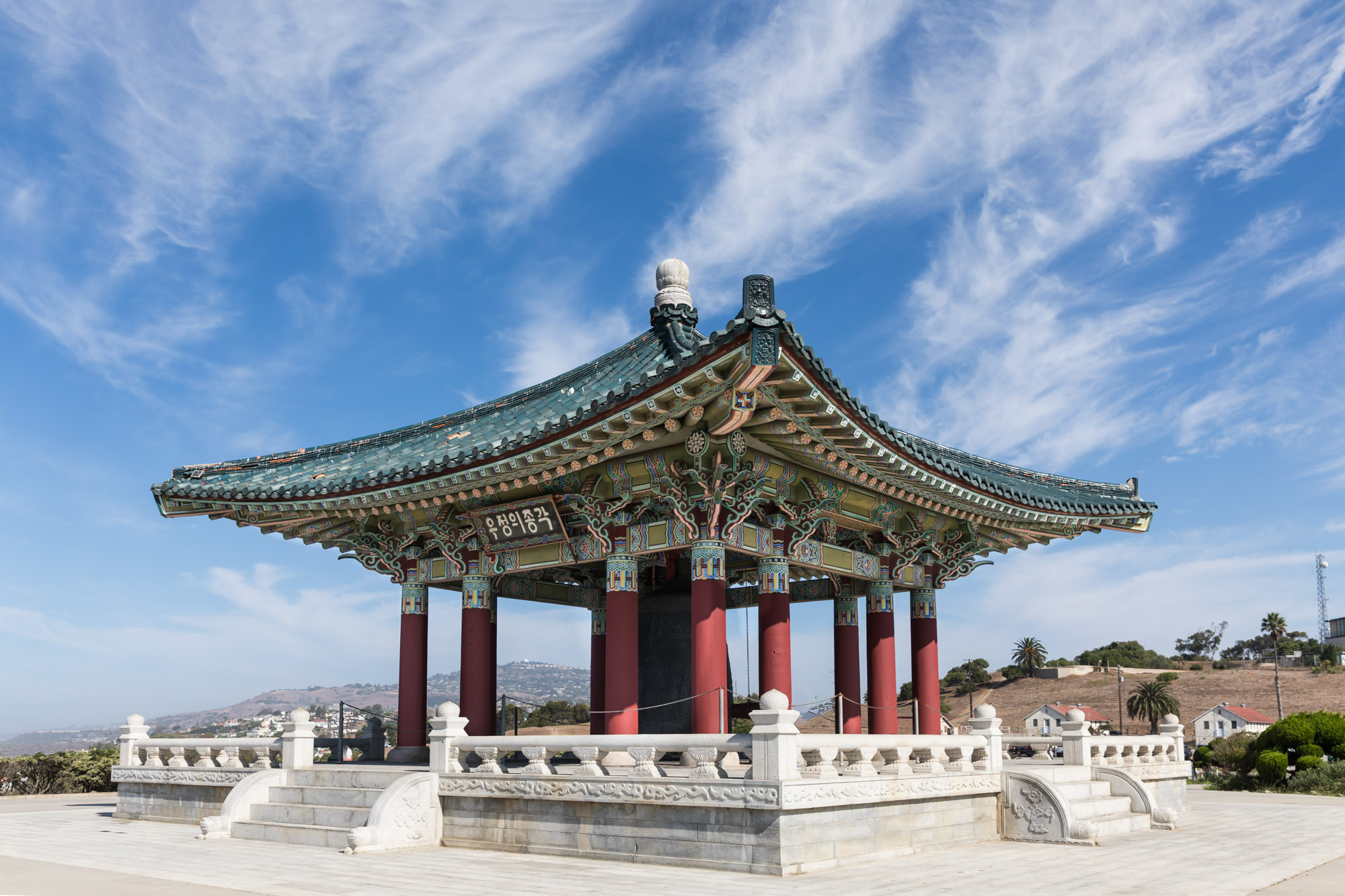 Korean Bell of Friendship with carved white railing surrounding the structure for an article on where to propose in Long Beach