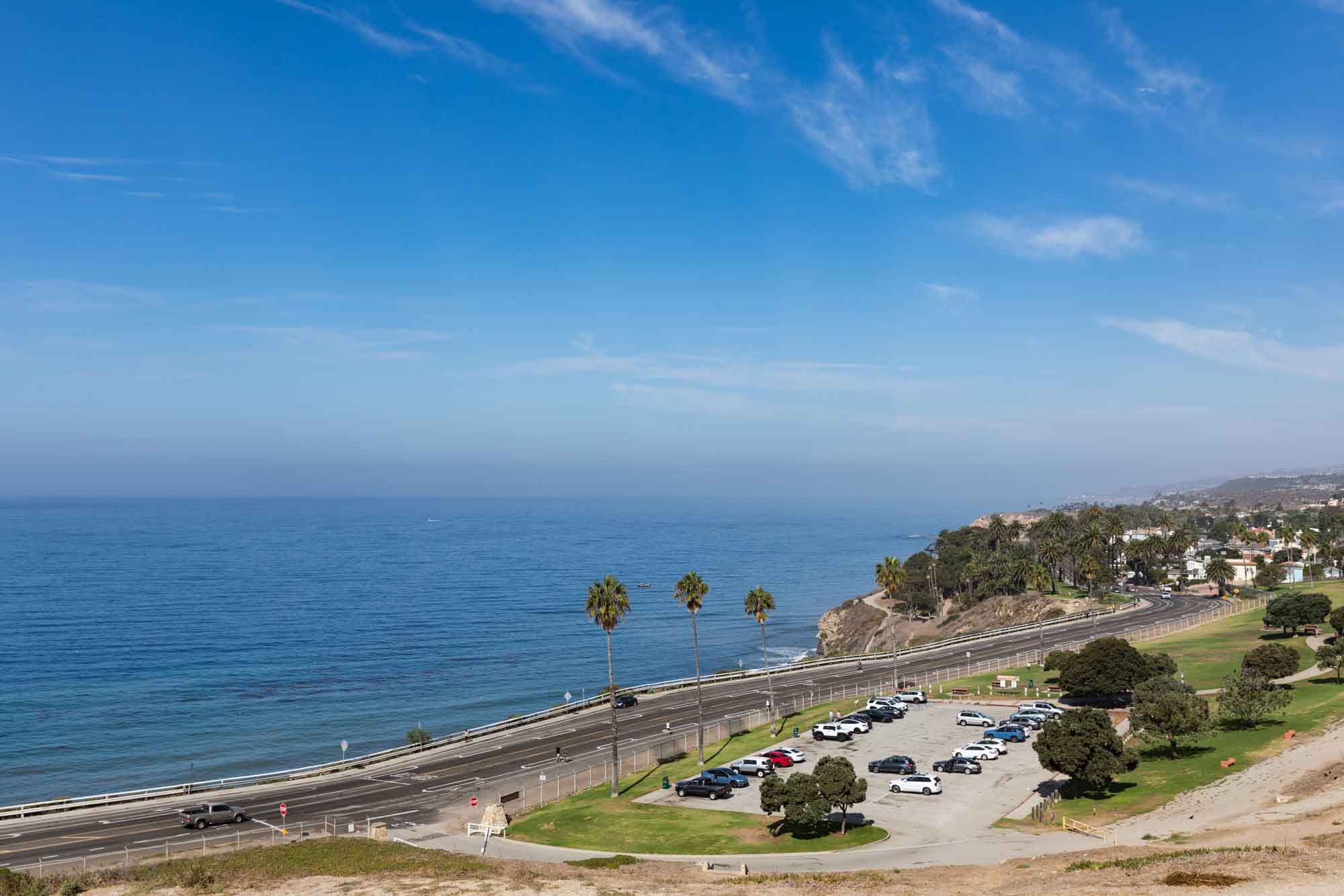 View of the Pacific Ocean, parking lot, and W. Paseo del Mar road from the Korean Bell of Friendship for an article on where to propose in Long Beach