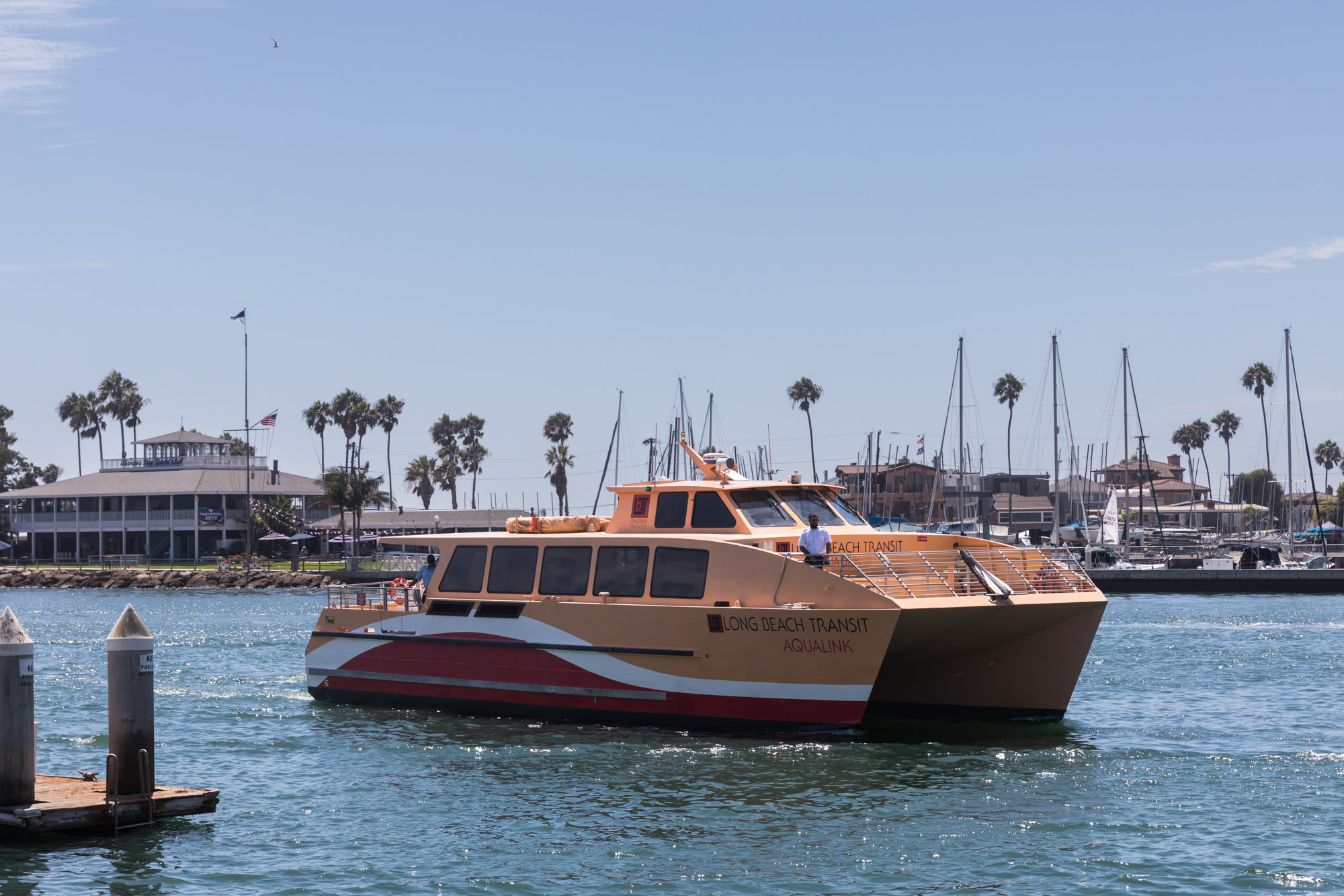 The AquaLink steering into dock in front of other ships in Alamitos Bay Landing Berth 3 for an article on where to propose in Long Beach