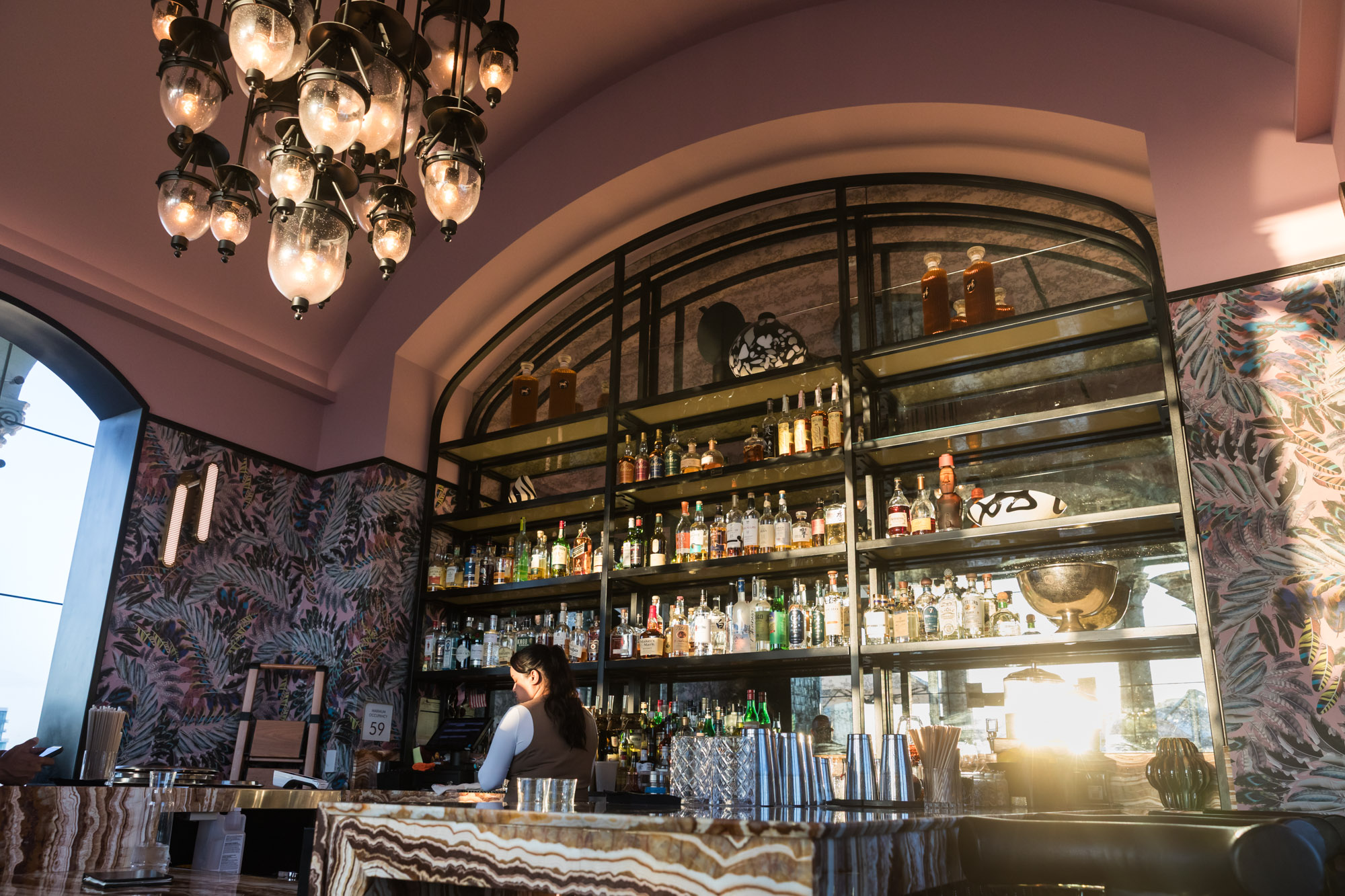 Interior bar of Halo Rooftop Bar at the Fairmont Breakers Long Beach Hotel with bottles stacked to the ceiling for an article on where to propose in Long Beach
