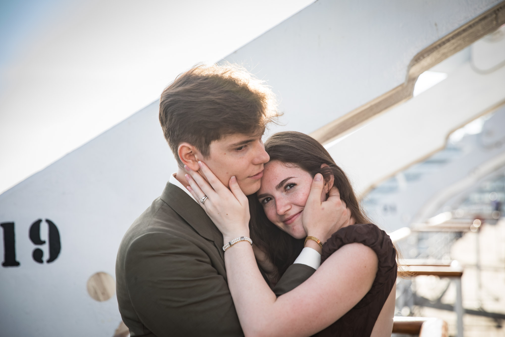 Woman smiling at the camera as the man holds her face, photographed by a Los Angeles photographer