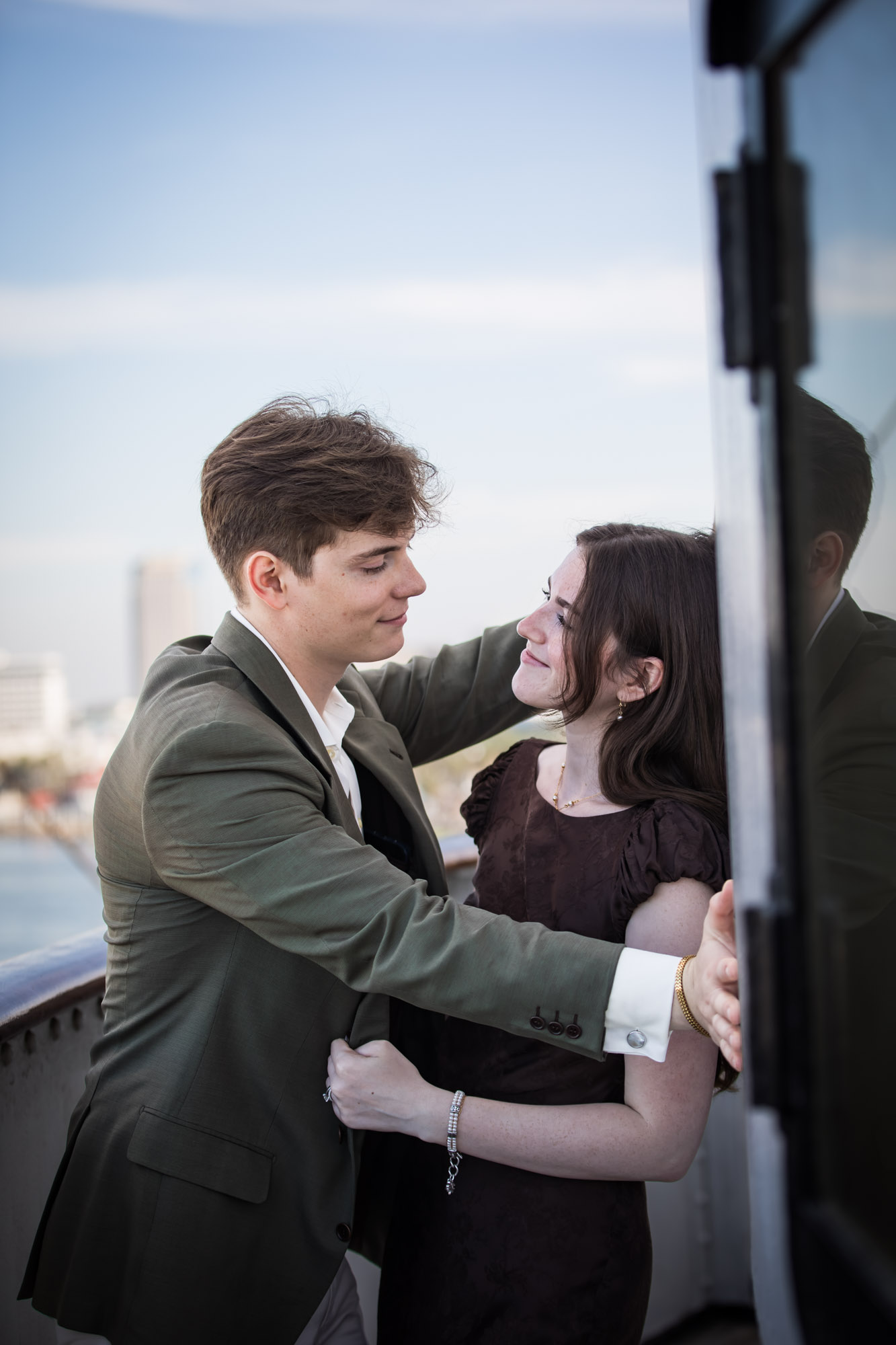Man smiling down at the woman as she looks up at him on the Bridge walkway, photographed by a Los Angeles photographer