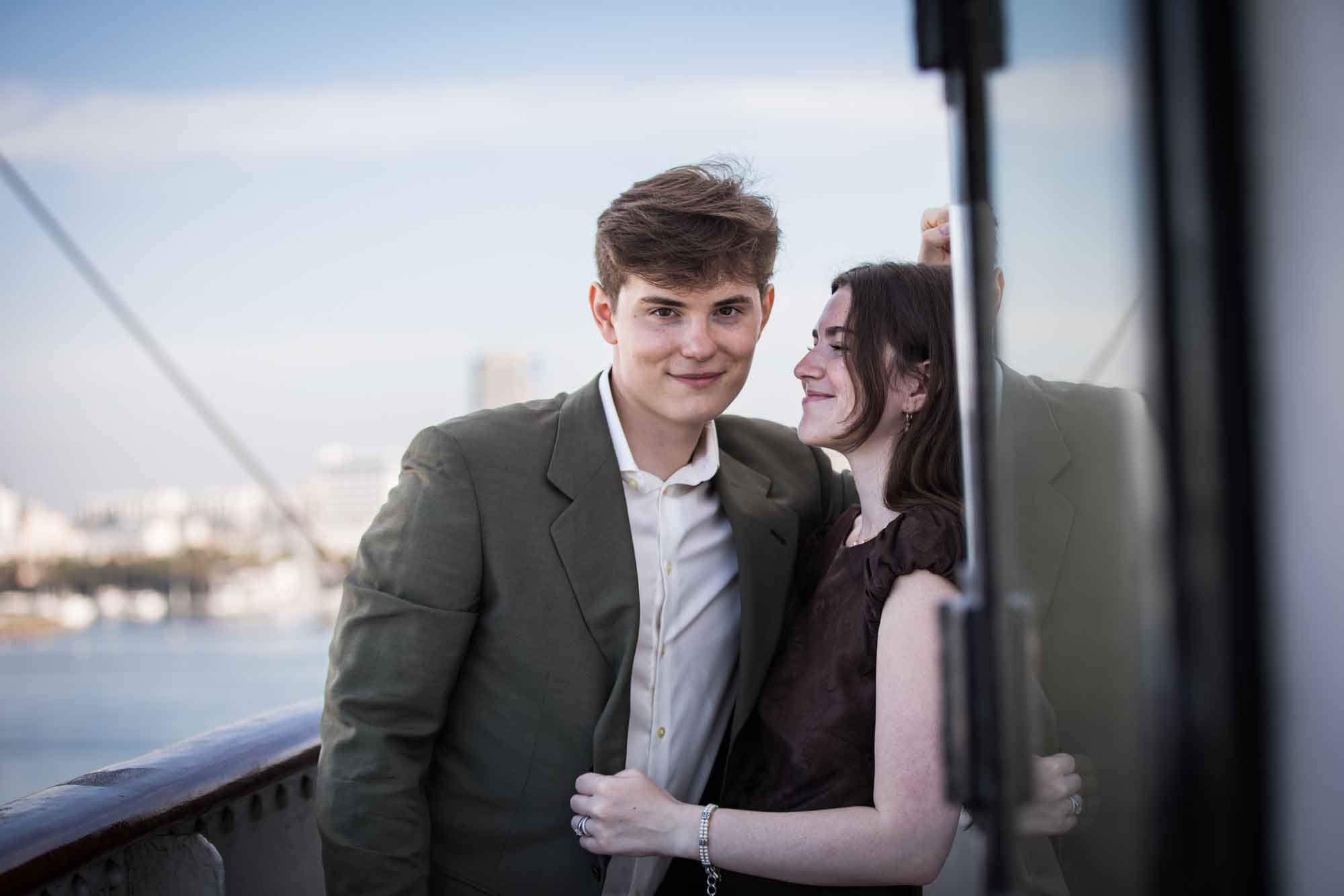Man smiling at the camera as the woman leans in with her eyes closed, photographed by a Long Beach photographer