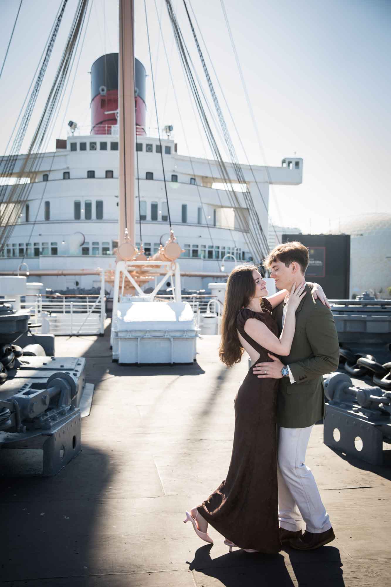 Couple sharing a romantic dance on the Queen Mary's bow, gazing at each other, Queen Mary photo shoot