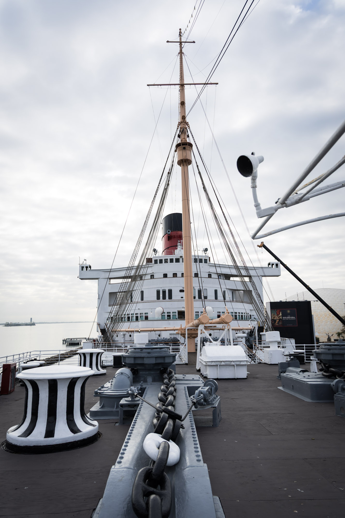 Striped capstans, anchor chain, and mast on the bow deck, a nautical setting for a Queen Mary photo shoot