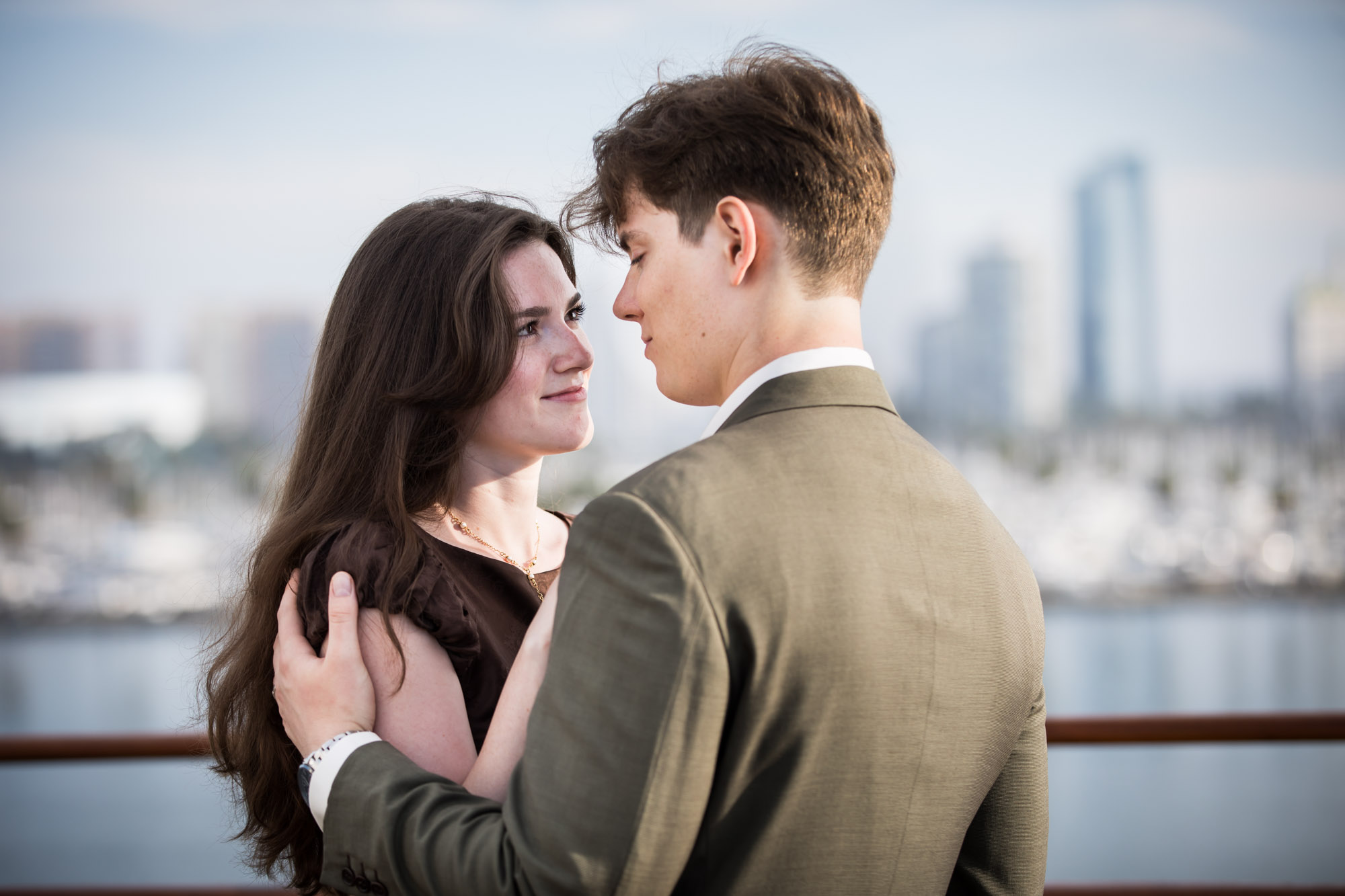 Woman smiling up at the man on the Queen Mary deck, a quiet moment from their Queen Mary photo shoot