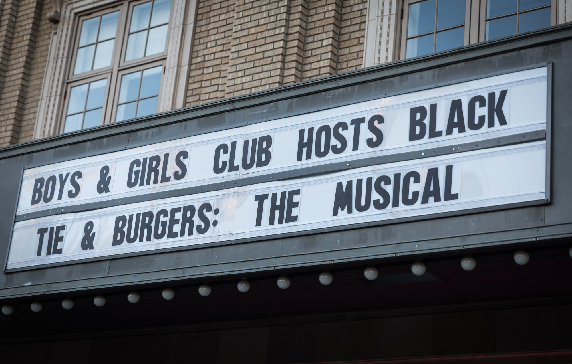 Raymond Theatre photos of the marquee announcing Boys & Girls Club hosts Black Tie & Burgers: The Musical